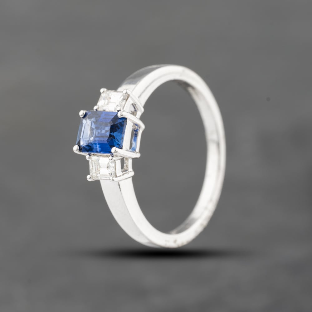 Pre-Owned 18ct White Gold 1.08ct Sapphire & 0.30ct Emerald Cut Diamond Three Stone Ring 43361146